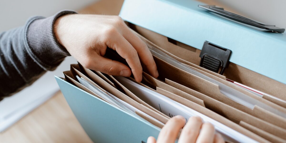 Person choosing document in folder