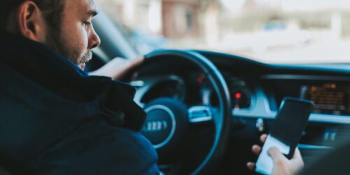 man holding black smartphone