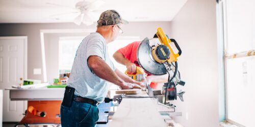 man standing infront of miter saw